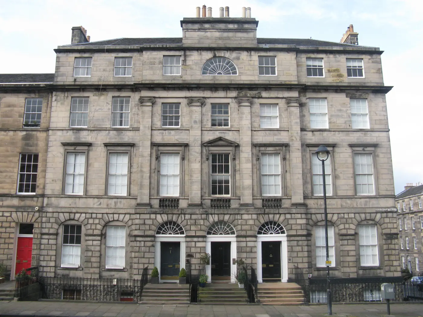 Georgian terrace elevation on Great King Street in Edinburgh New Town, with railings and the basement area below pavement level.