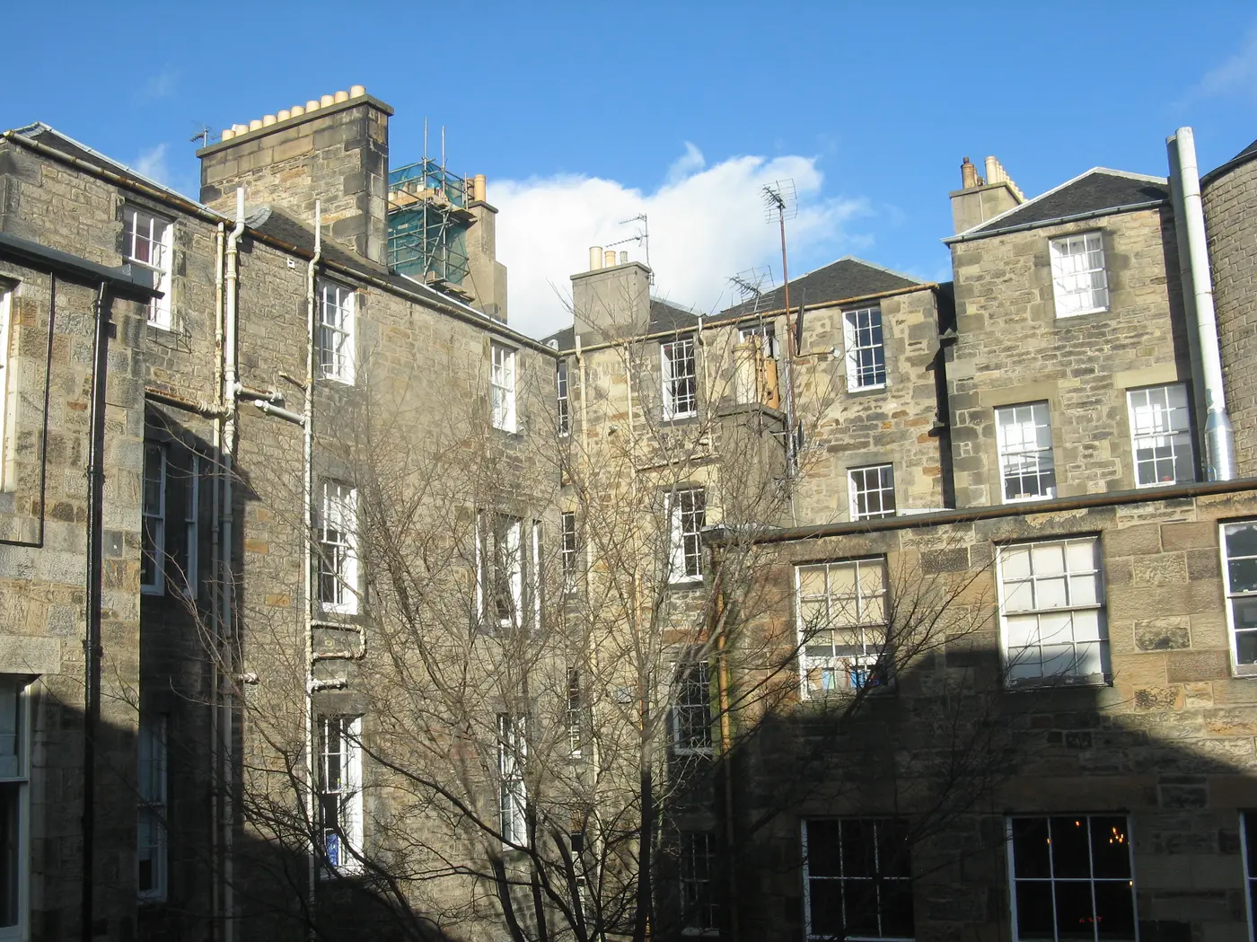Rear elevation of Georgian tenements at Queen Street and Hanover Street in Edinburgh, with cast iron rainwater goods running down the stonework.