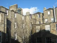 Rear elevation of Georgian tenements at Queen Street and Hanover Street, Edinburgh, with cast-iron rainwater downpipes running down the stone